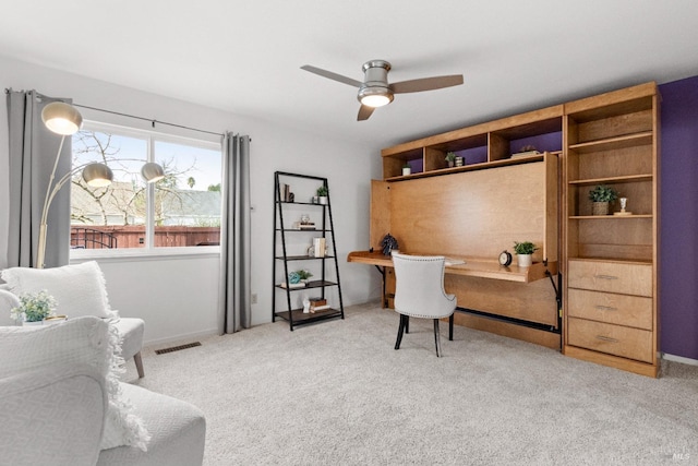 carpeted office featuring visible vents and a ceiling fan