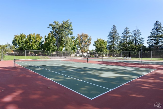 view of sport court featuring fence