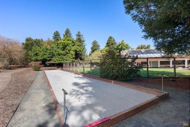 view of home's community featuring fence