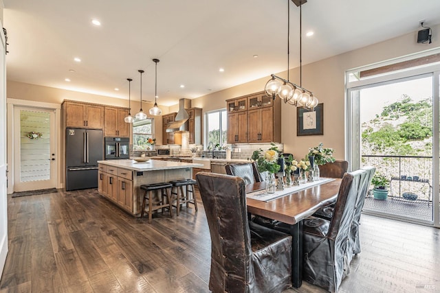 kitchen with dark wood-style flooring, a barn door, open floor plan, backsplash, and beverage cooler