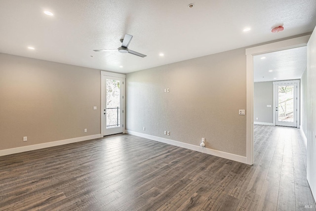 spare room featuring ceiling fan, baseboards, dark wood-style floors, and recessed lighting