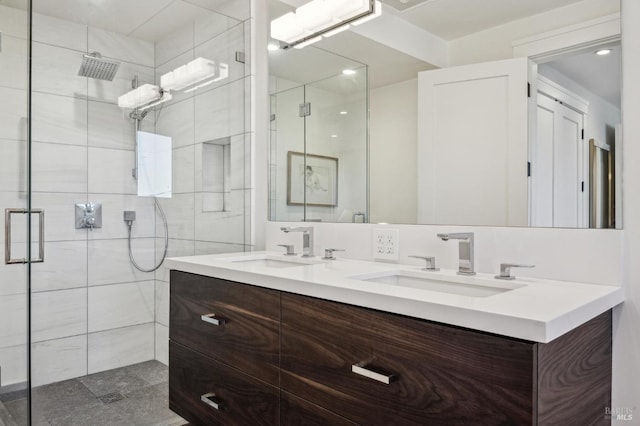 full bath with double vanity, a sink, and a shower stall