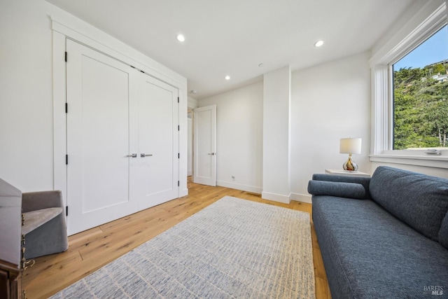 interior space with light wood-type flooring, baseboards, and recessed lighting