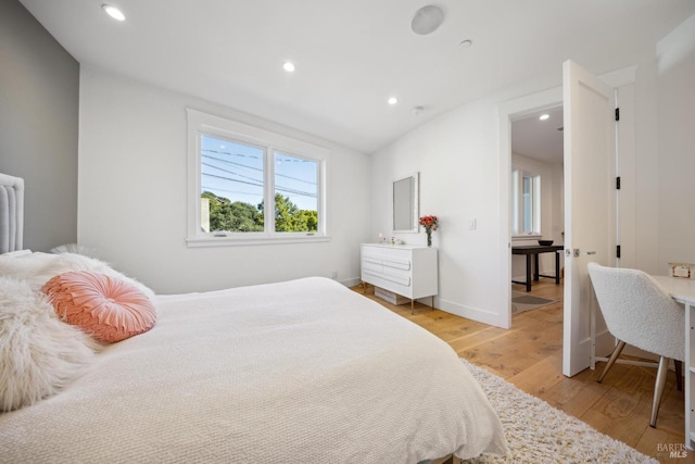 bedroom with recessed lighting, baseboards, and light wood finished floors