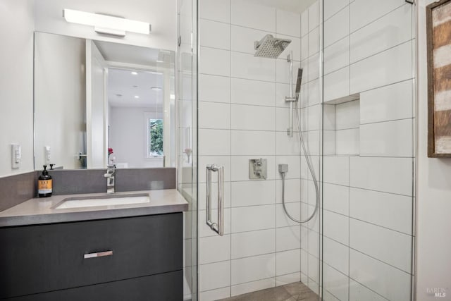 bathroom featuring a shower stall and vanity