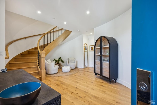 interior space featuring wood-type flooring, baseboards, and recessed lighting