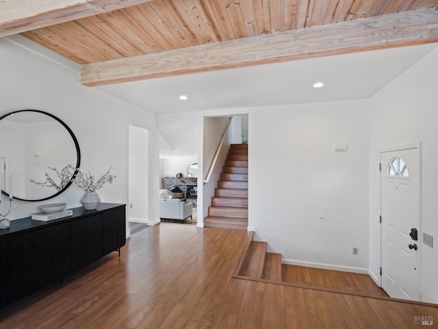 foyer entrance featuring wood finished floors, recessed lighting, stairway, beam ceiling, and wooden ceiling