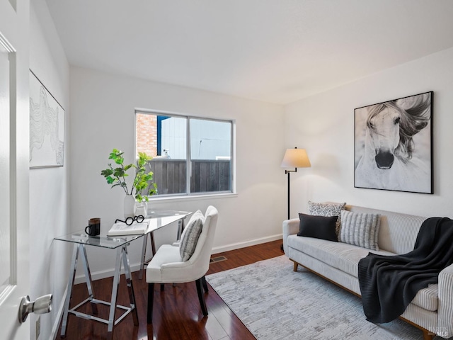 home office with baseboards and wood finished floors