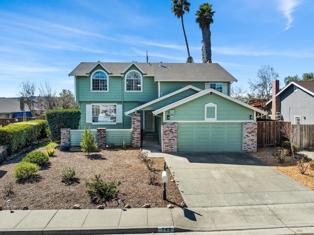 view of front of house with a garage, concrete driveway, brick siding, and fence