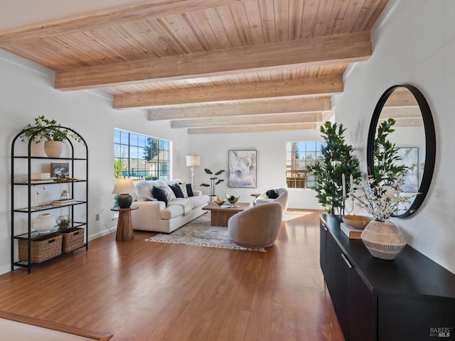 living room featuring beamed ceiling, wooden ceiling, wood finished floors, and baseboards