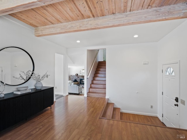 entryway featuring recessed lighting, wood finished floors, wood ceiling, stairway, and beam ceiling