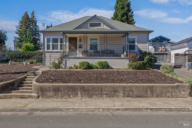 view of front facade featuring covered porch and stairs