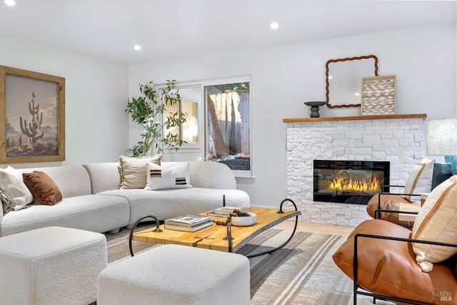 living area featuring a fireplace, wood finished floors, and recessed lighting