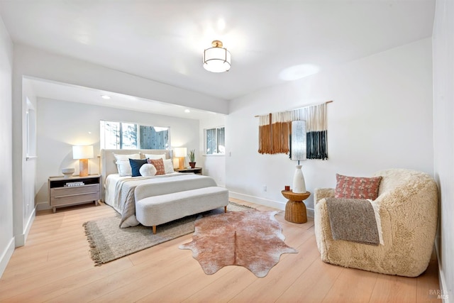 bedroom featuring baseboards and wood finished floors