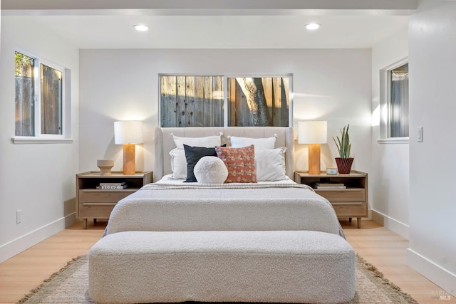 bedroom featuring light wood finished floors, baseboards, and recessed lighting