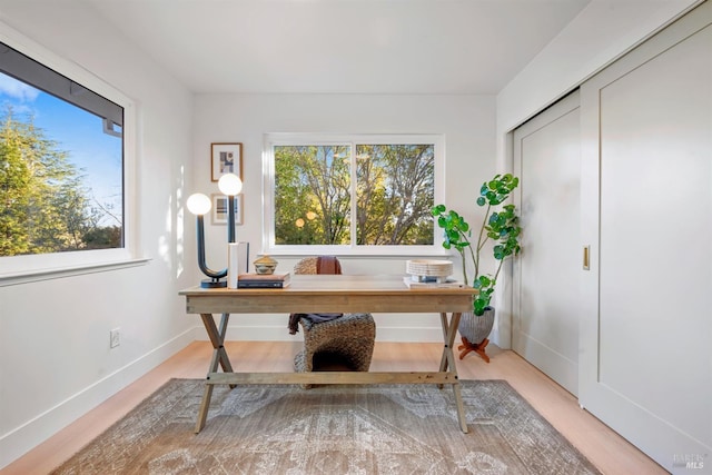 office area featuring baseboards and wood finished floors