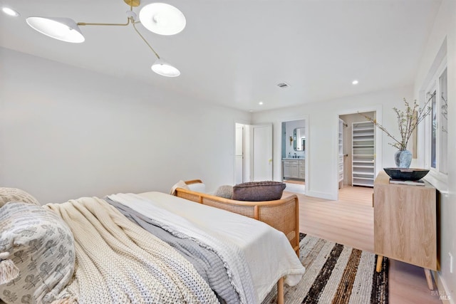 bedroom featuring light wood-type flooring, visible vents, baseboards, and recessed lighting