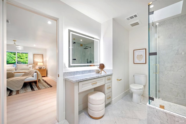 ensuite bathroom featuring a stall shower, visible vents, toilet, and ensuite bath