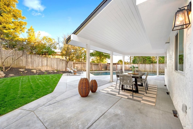 view of patio featuring outdoor dining area, a fenced backyard, and a fenced in pool