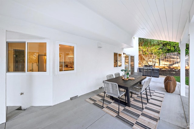 view of patio / terrace with a grill, fence, and outdoor dining area