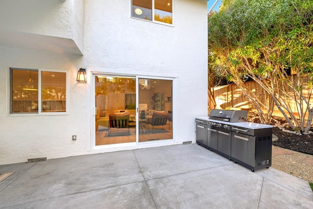 view of patio featuring a grill and fence