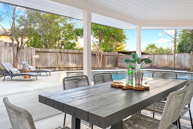 exterior space featuring outdoor dining area and a fenced backyard