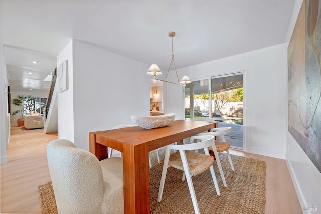 dining room featuring recessed lighting, stairway, light wood-style floors, a chandelier, and baseboards