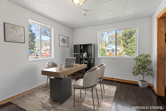 office area with plenty of natural light, wood-type flooring, baseboards, and a textured ceiling