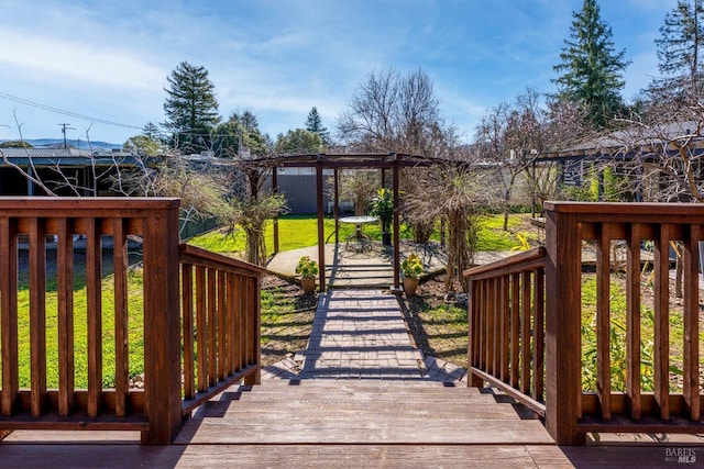 wooden deck featuring a yard