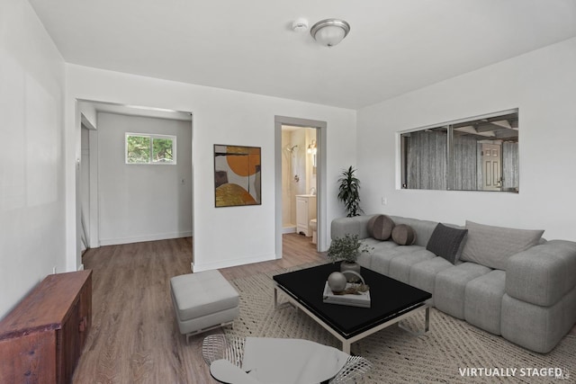 living room featuring wood finished floors and baseboards