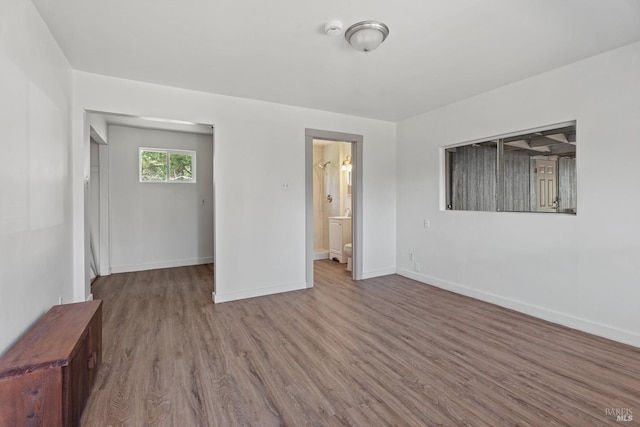 interior space with baseboards and wood finished floors