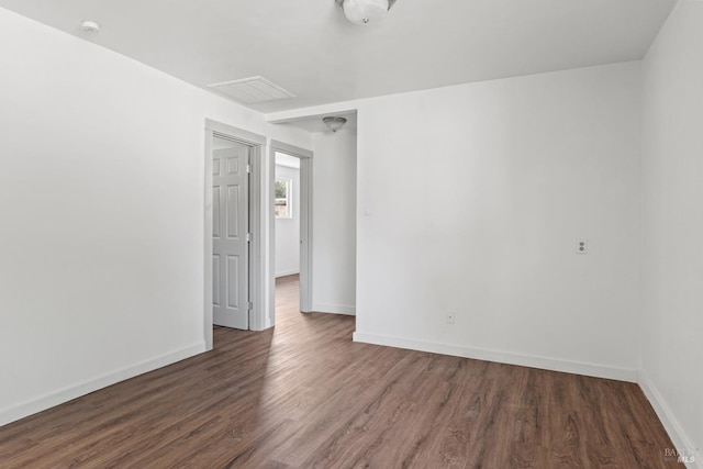 empty room featuring baseboards and wood finished floors