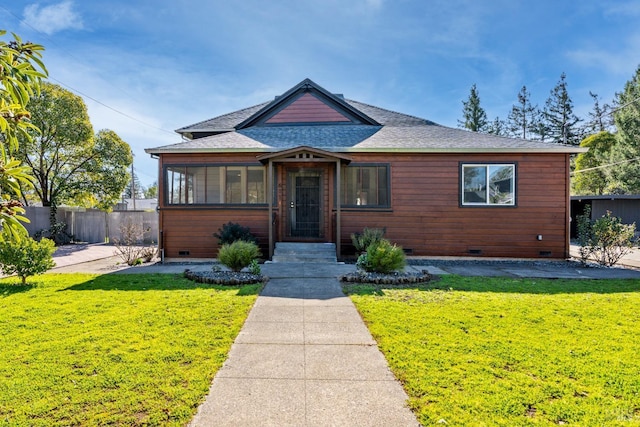 view of front of house featuring a shingled roof, a front yard, crawl space, and fence