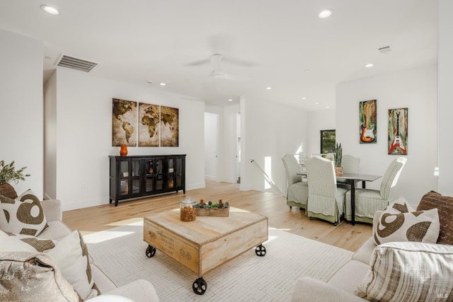 living room with baseboards, recessed lighting, visible vents, and light wood-type flooring