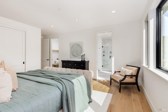 bedroom with recessed lighting, light wood-type flooring, and baseboards