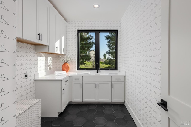 kitchen featuring a sink, dark tile patterned flooring, recessed lighting, and white cabinetry