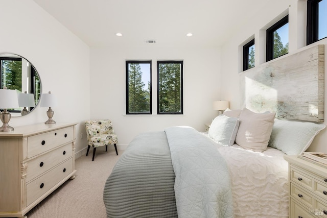 bedroom with light carpet, visible vents, recessed lighting, and baseboards