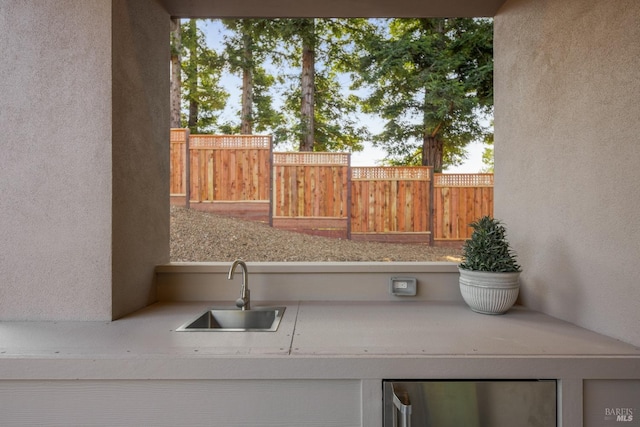 view of patio / terrace with a sink and fence