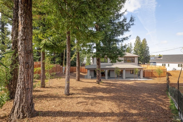 back of house with stucco siding and fence private yard