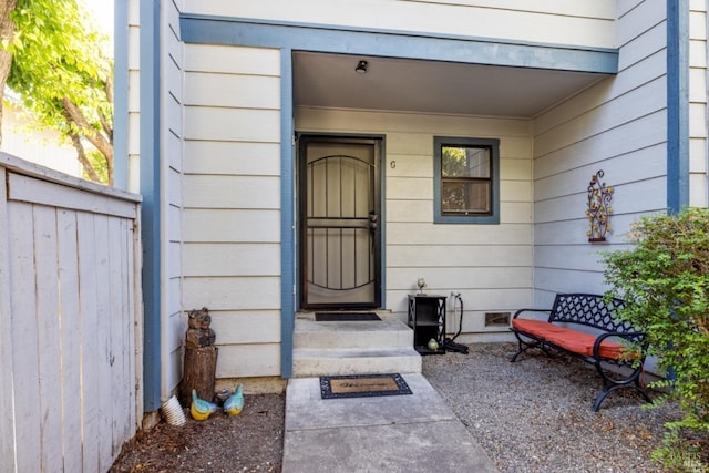 doorway to property featuring crawl space and fence