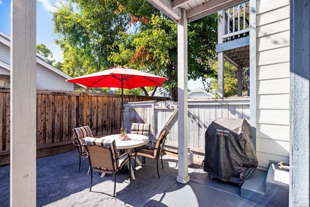 view of patio / terrace with fence, grilling area, and outdoor dining space