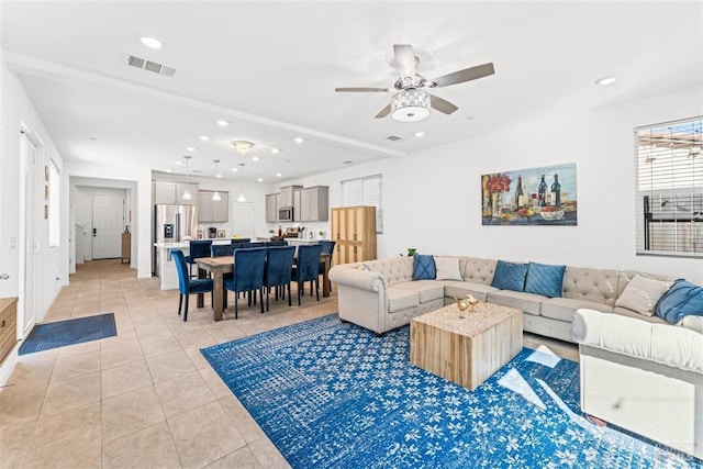 living room with light tile patterned flooring, a ceiling fan, visible vents, and recessed lighting
