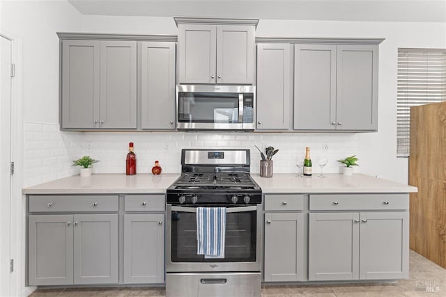 kitchen with gray cabinetry and stainless steel appliances
