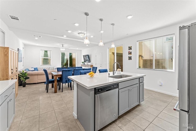 kitchen with gray cabinets, light tile patterned floors, visible vents, appliances with stainless steel finishes, and a sink