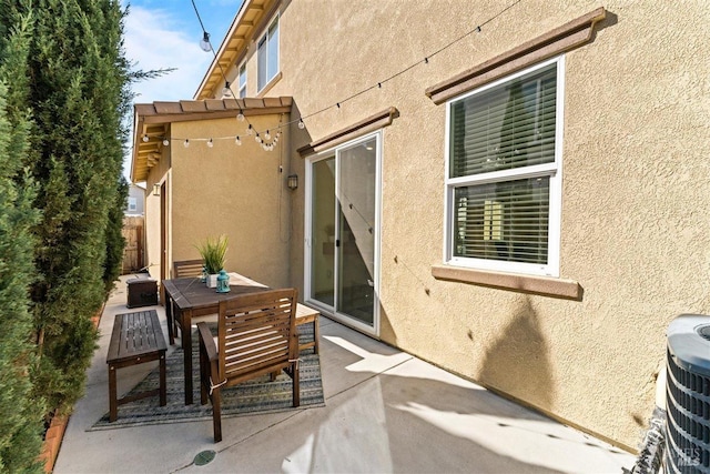 view of patio featuring central air condition unit and outdoor dining area