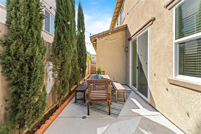 view of patio / terrace featuring fence