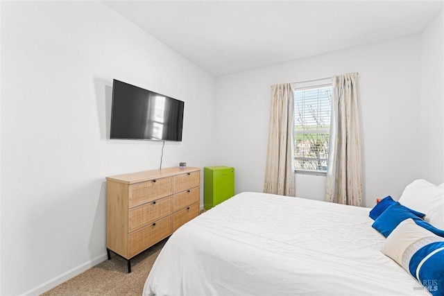 bedroom featuring carpet and baseboards
