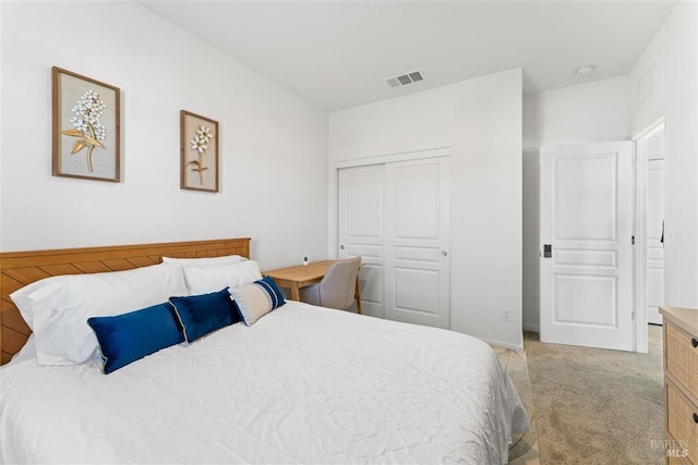 bedroom featuring light carpet, visible vents, and a closet