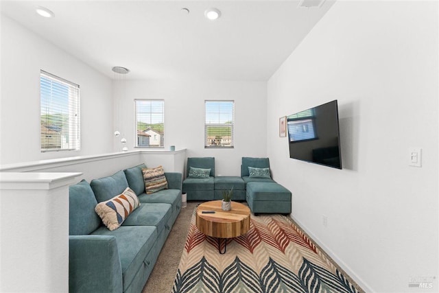 carpeted living area featuring a wealth of natural light, recessed lighting, and baseboards