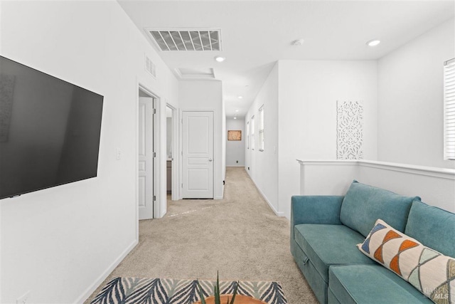interior space with light carpet, recessed lighting, visible vents, and baseboards